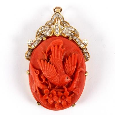 Appraisal: A carved coral pendant of oval shape depicting a bird