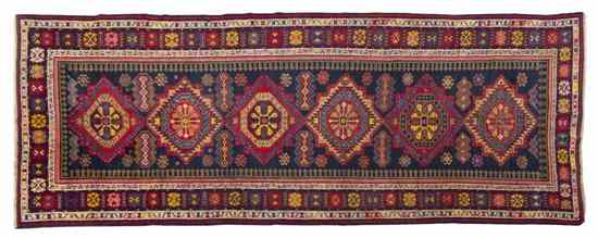 Appraisal: A Caucasian Wool Runner having six stylized geometric medallions on