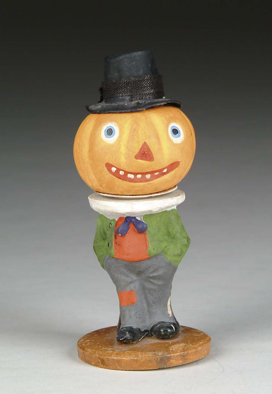 Appraisal: FIGURAL PUMPKIN CANDY CONTAINER Top-hatted composition jack-o-lantern with hand painted