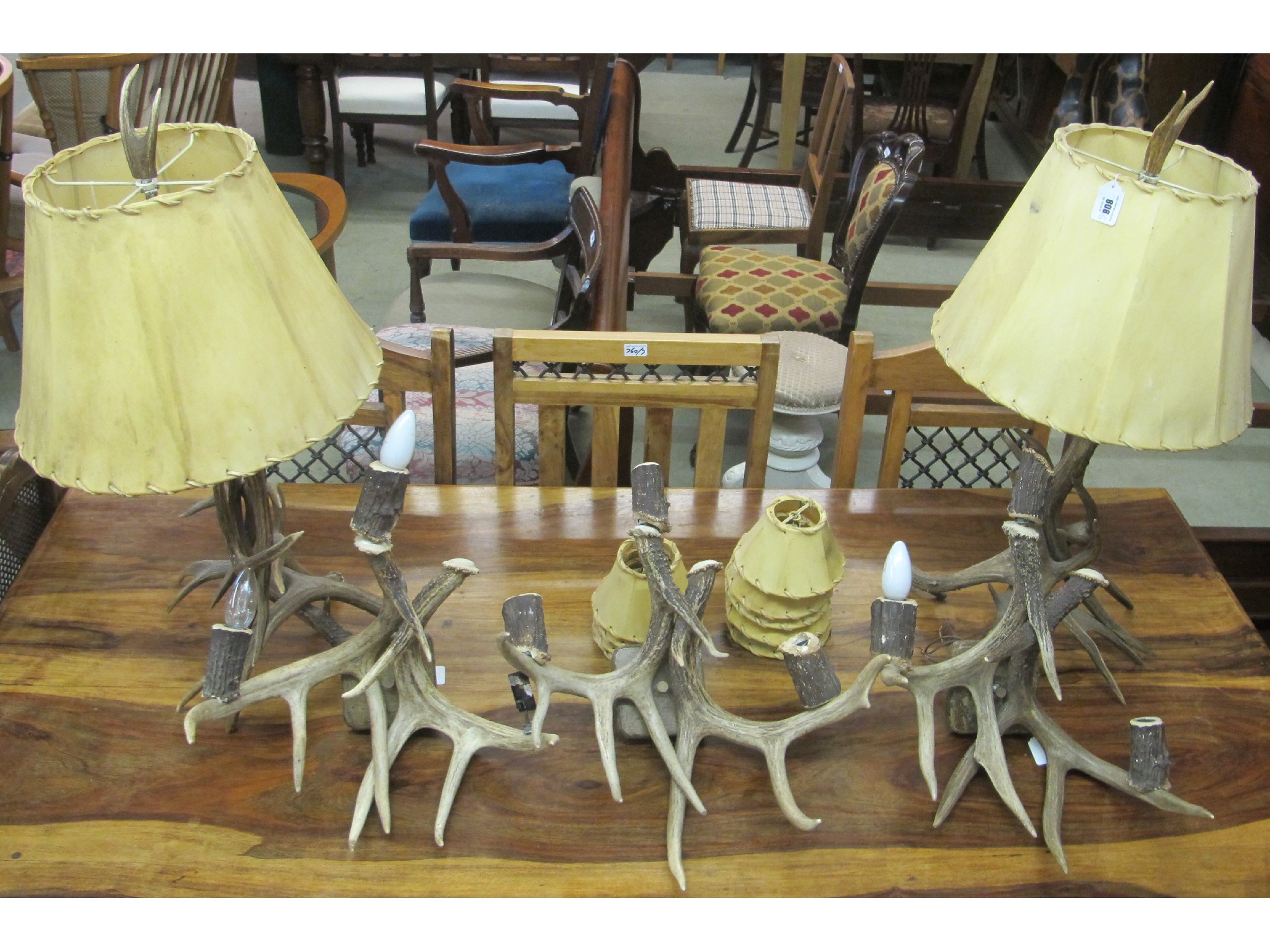 Appraisal: Two antler table lamps with hide shades and three antler