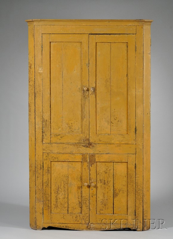 Appraisal: Mustard-painted Wood Four-Door Corner Cupboard the upper cabinet with three