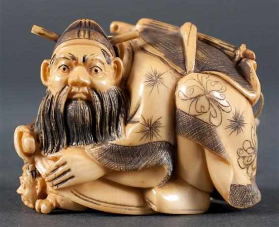 Appraisal: Japanese carved ivory netsuke shoki capturing oni under a basket