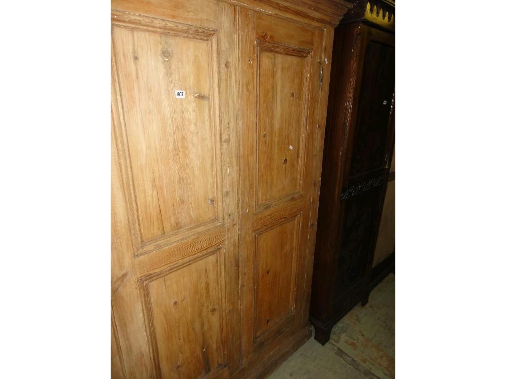 Appraisal: A stripped pine kitchen cupboard enclosed by a pair of