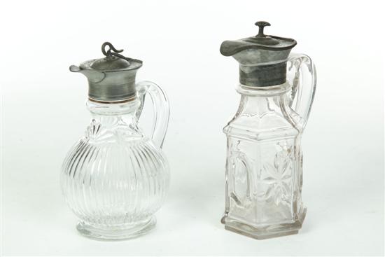 Appraisal: TWO GLASS SYRUP PITCHERS American mid th century Pattern glass