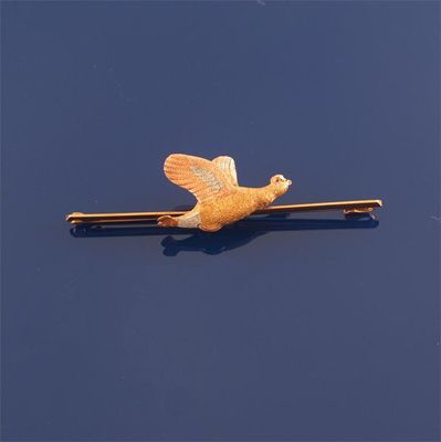 Appraisal: A three colour gold flying grouse bar brooch With ruby