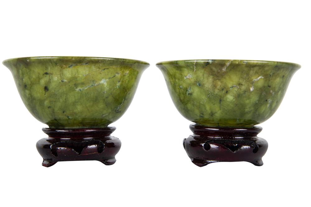 Appraisal: PAIR OF SMALL CHINESE JADE BOWLSeach with wooden stand together