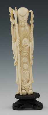 Appraisal: Carved Ivory Standing Monk Standing monk holding peach and with