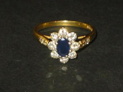 Appraisal: A SAPPHIRE AND DIAMOND CLUSTER RING the oval cut sapphire