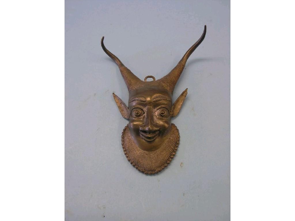 Appraisal: An African cast brass mask character with long ears and