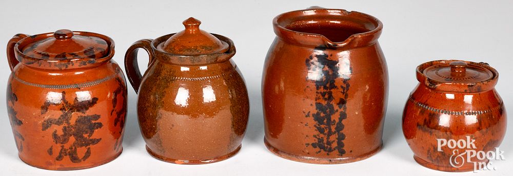 Appraisal: Four Pennsylvania redware pitchers th c Four Pennsylvania redware pitchers