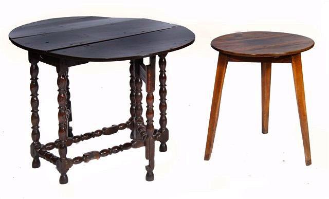 Appraisal: AN ANTIQUE WALNUT CIRCULAR CRICKET TABLE on three square tapering