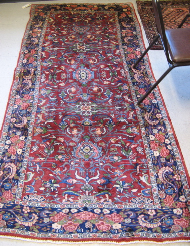 Appraisal: PERSIAN AREA RUG hand knotted in an overall floral design