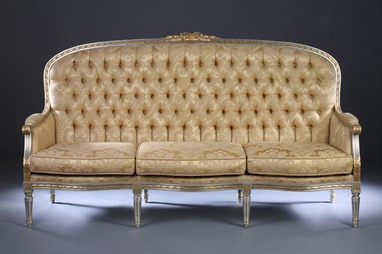 Appraisal: LOUIS XVI-STYLE SILVER LEAF AND GILT-ACCENTED CANAPE late th century