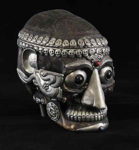 Appraisal: A Tibetan white metal mounted skull and kapala the cranium