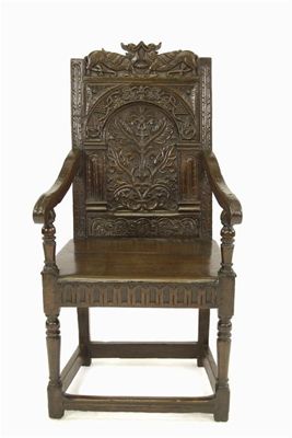 Appraisal: A carved oak panel back armchair with a twin beast