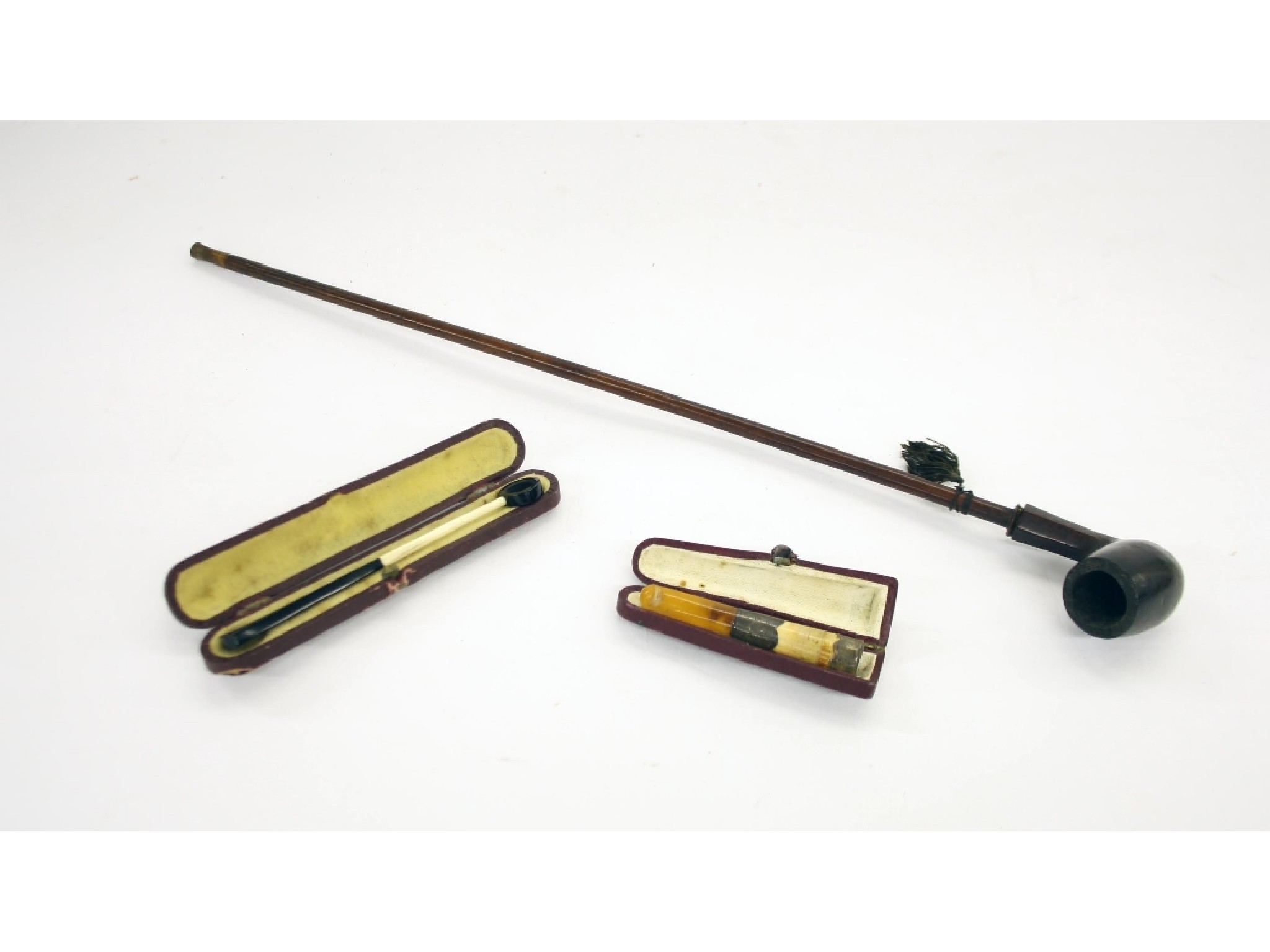 Appraisal: Collection of smoking items to include long wooden pipe cigarette