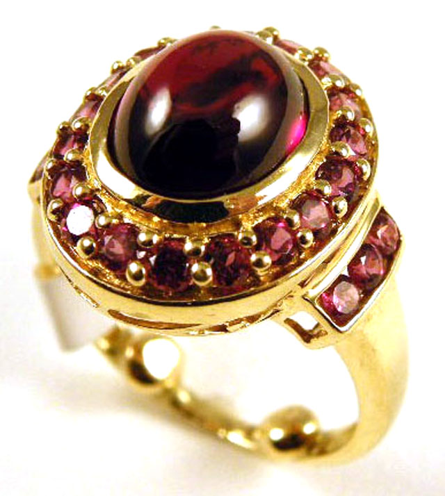 Appraisal: RED CABOCHON AND FOURTEEN KARAT GOLD RING centering an oval