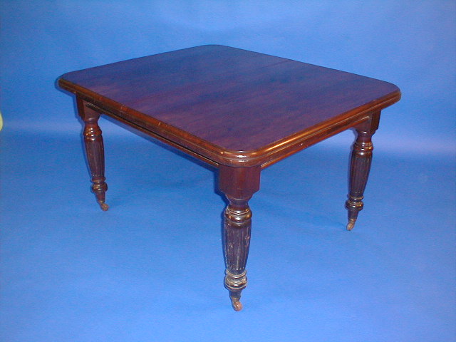 Appraisal: A late Victorian walnut wind-out dining table with leaf and