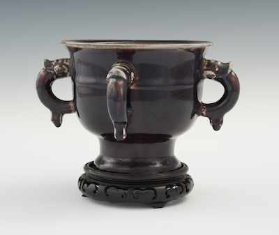 Appraisal: A Chinese Four-Handle Footed Bowl Ch'ing Aubergine sang de boeuf