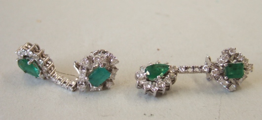 Appraisal: A pair of diamond and emerald set pendant earrings each