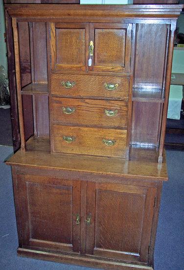 Appraisal: An oak Arts Crafts style cabinet the moulded cornice above