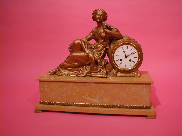 Appraisal: A French brown marble figural mantel clock having a seated