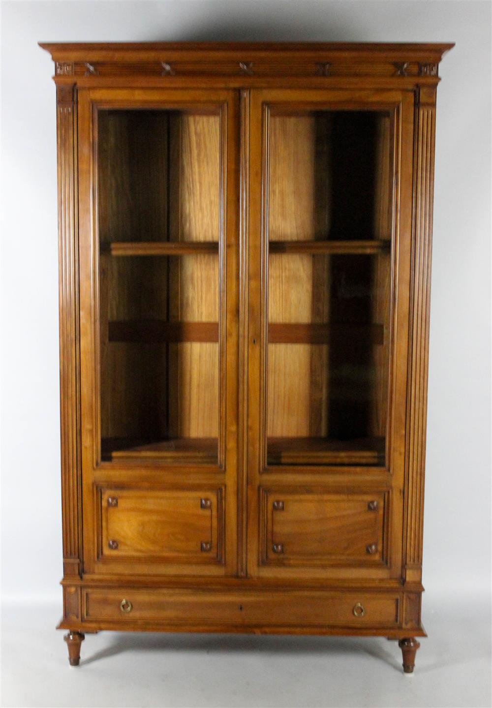 Appraisal: LOUIS XVI STYLE WALNUT BIBLIOTEQUE TH CENTURY the molded rectangular