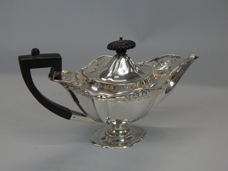 Appraisal: An Edwardian silver teapot with a pierced border ebonised knop