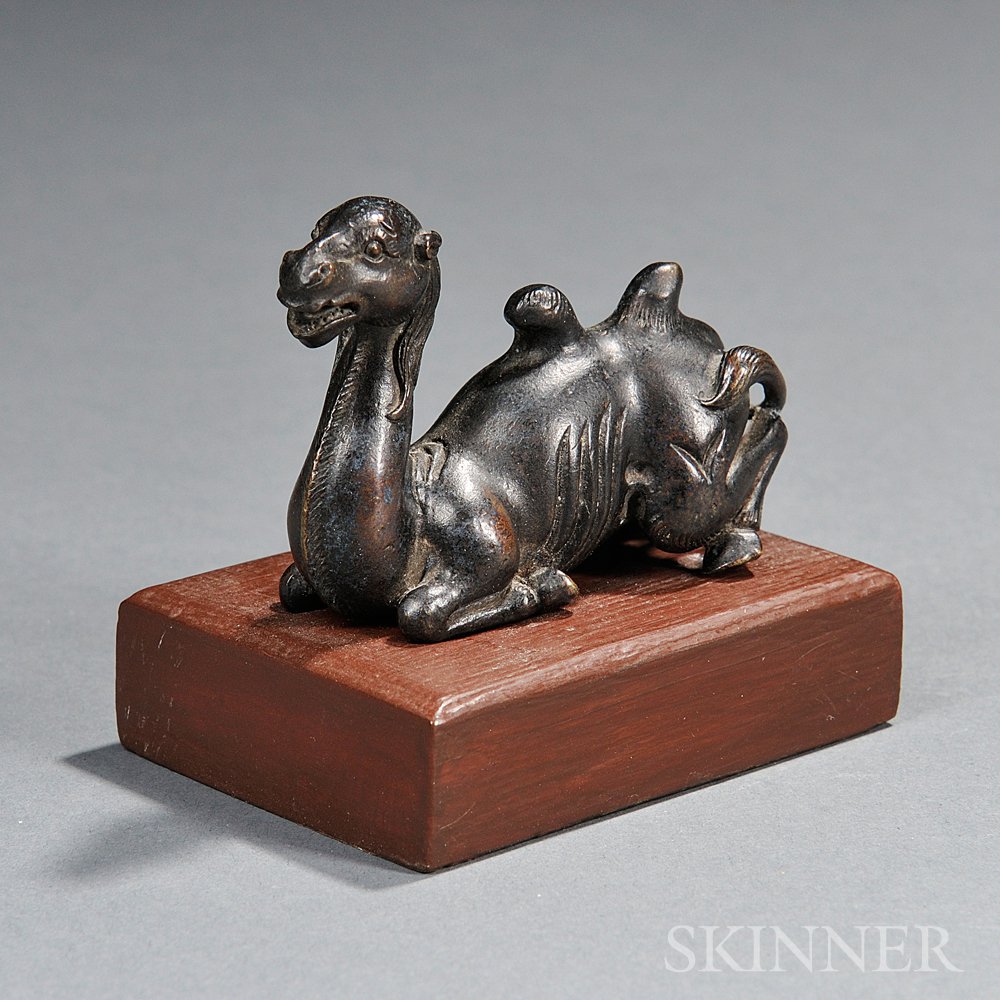 Appraisal: Bronze Camel China depicted seated with a modern wood stand