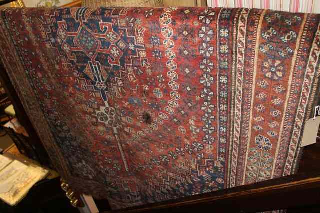 Appraisal: AN EASTERN WOOL RUG of red ground with central medallion