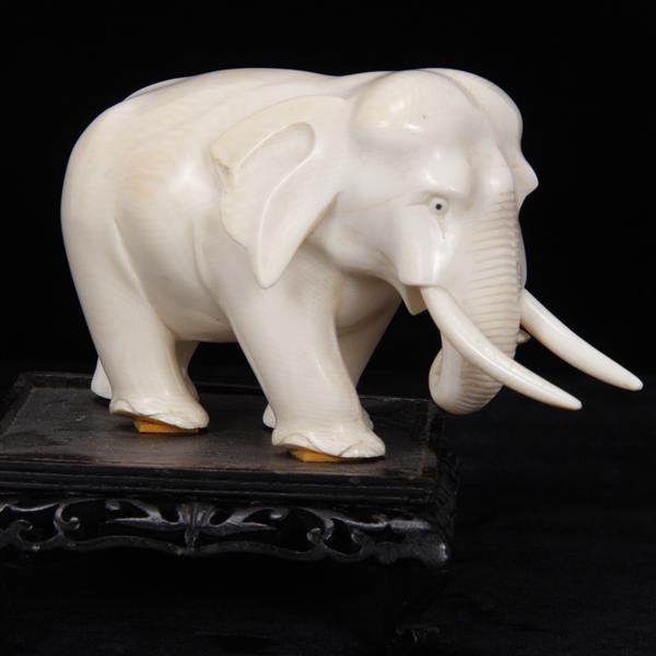 Appraisal: Asian carved ivory elephant figure on carved wooden stand H