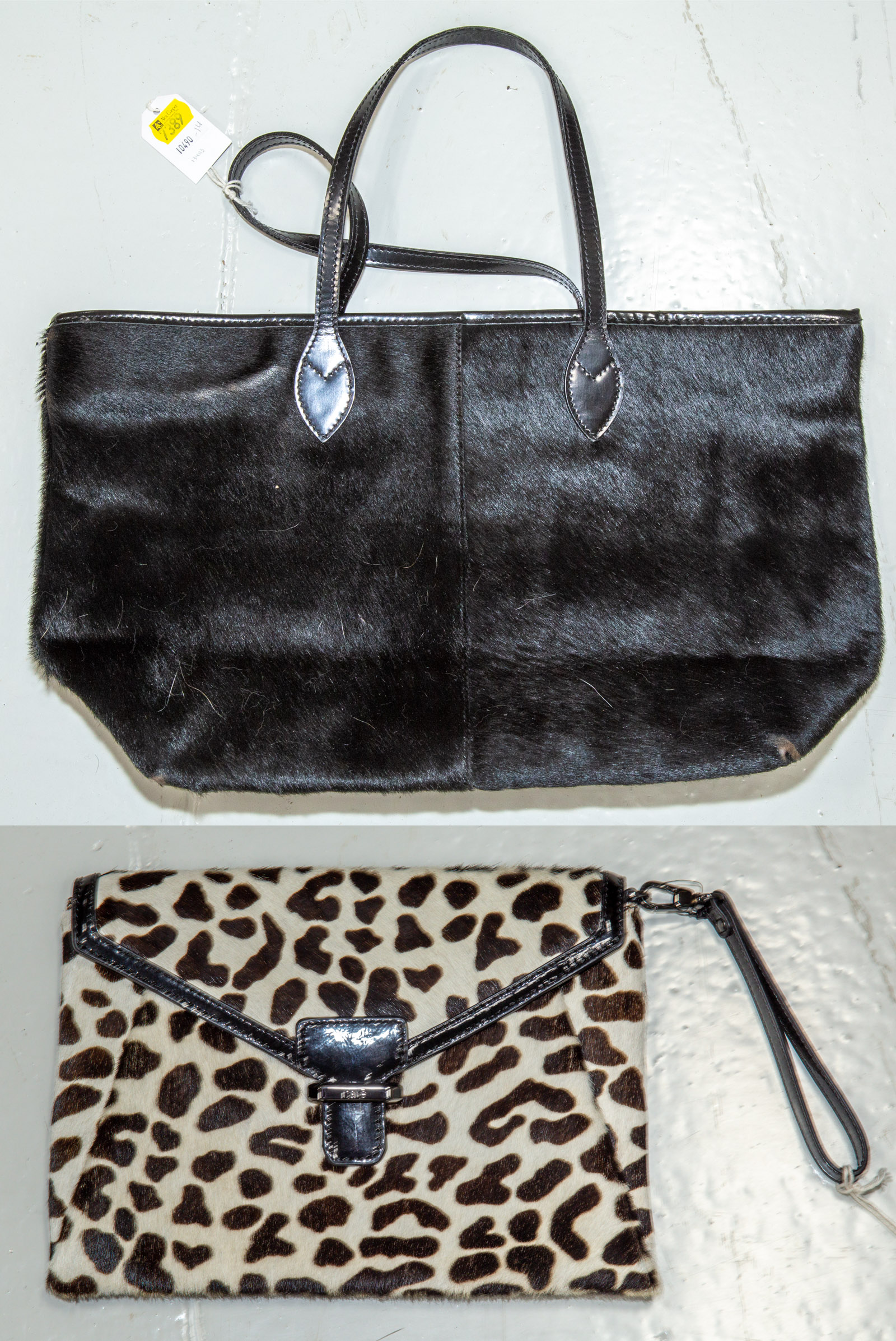 Appraisal: A CALF HAIR TOTE RAFE CLUTCH A black Don Caster