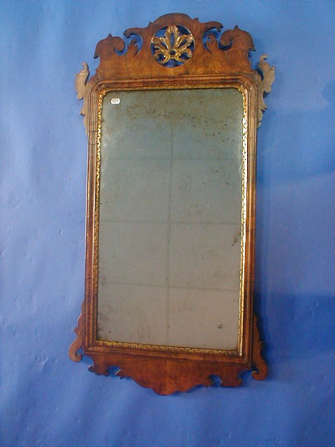 Appraisal: A mid th century walnut framed wall mirror with fret