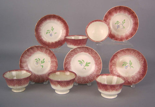 Appraisal: Five red spatter cups and saucers th c with sprig