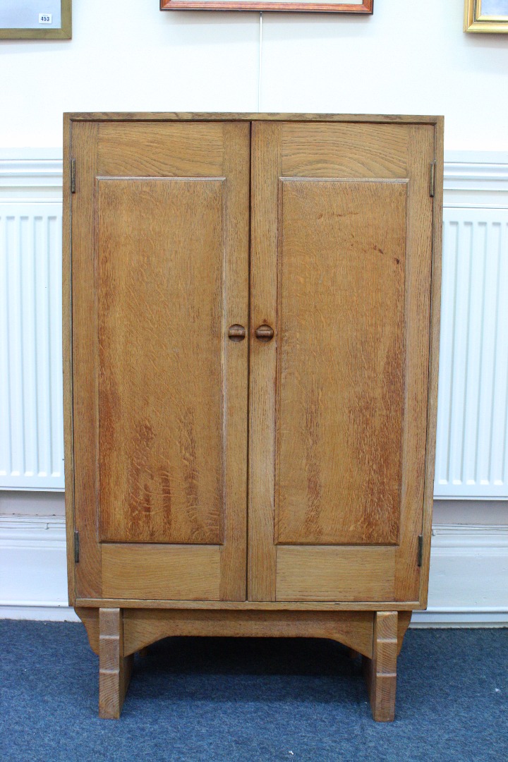 Appraisal: A golden oak linen cupboard by Peter Waals circa the