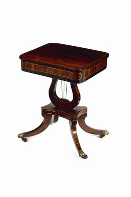 Appraisal: A rosewood and brass inlaid low work table the hinged