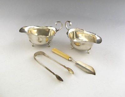 Appraisal: A pair of silver sauce boats oval form wavy edge