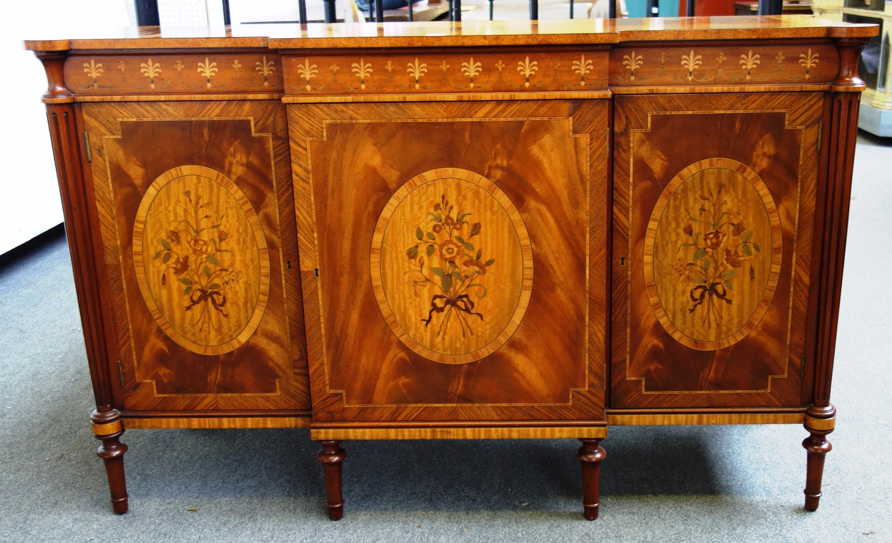 Appraisal: An th century style marquetry inlaid mahogany satinwood amboyna and