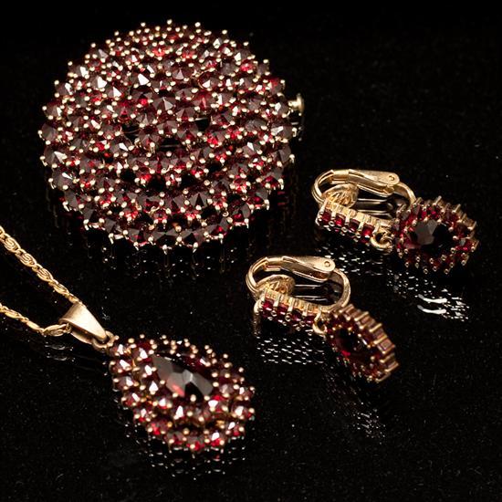 Appraisal: Assorted K yellow gold and garnet jewelry dome form brooch