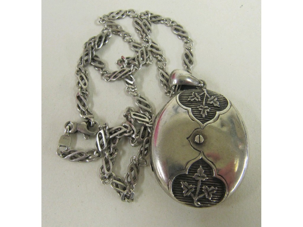 Appraisal: White metal locket with embossed leaf decoration on fancy link