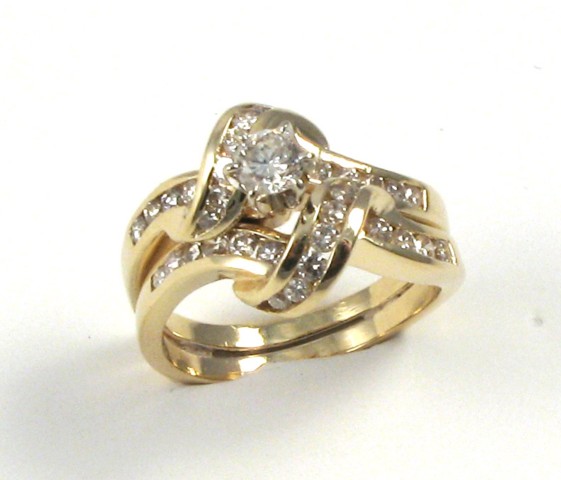 Appraisal: DIAMOND AND FOURTEEN KARAT GOLD RING centering a round brilliant-cut