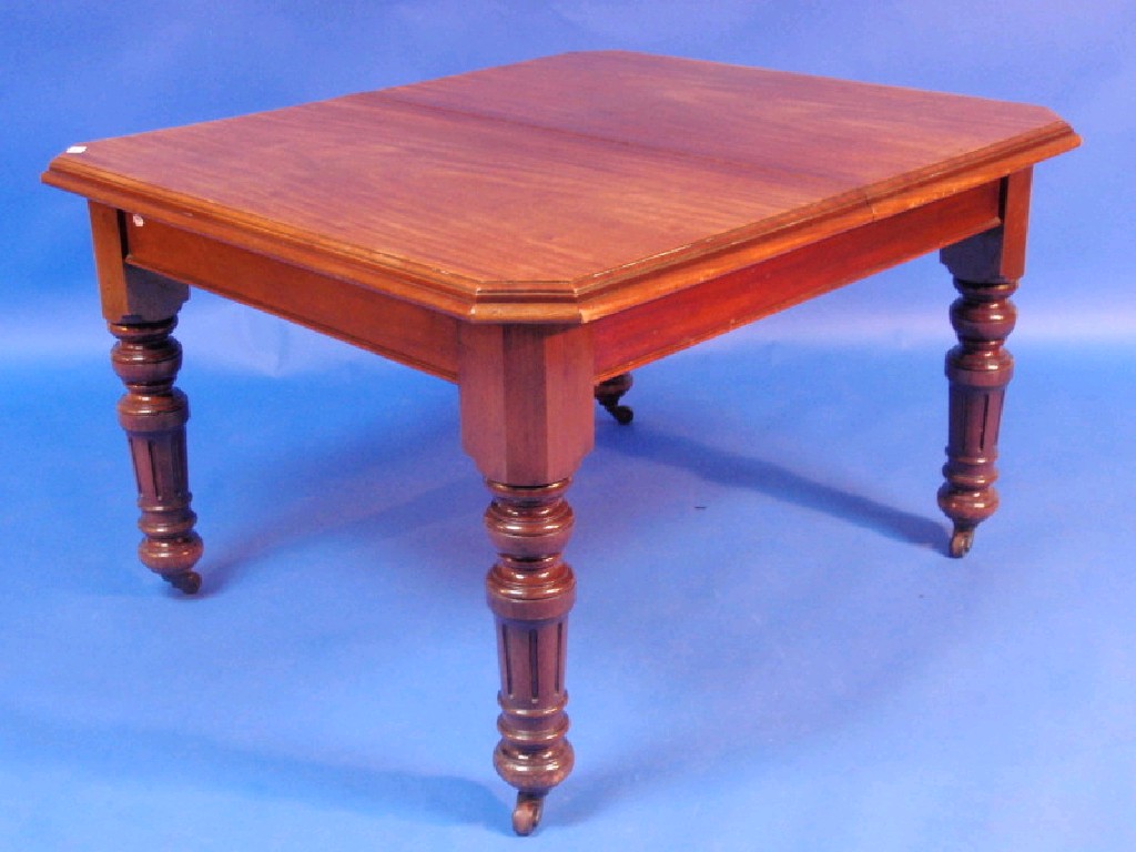 Appraisal: A late Victorian walnut dining table with moulded and canted