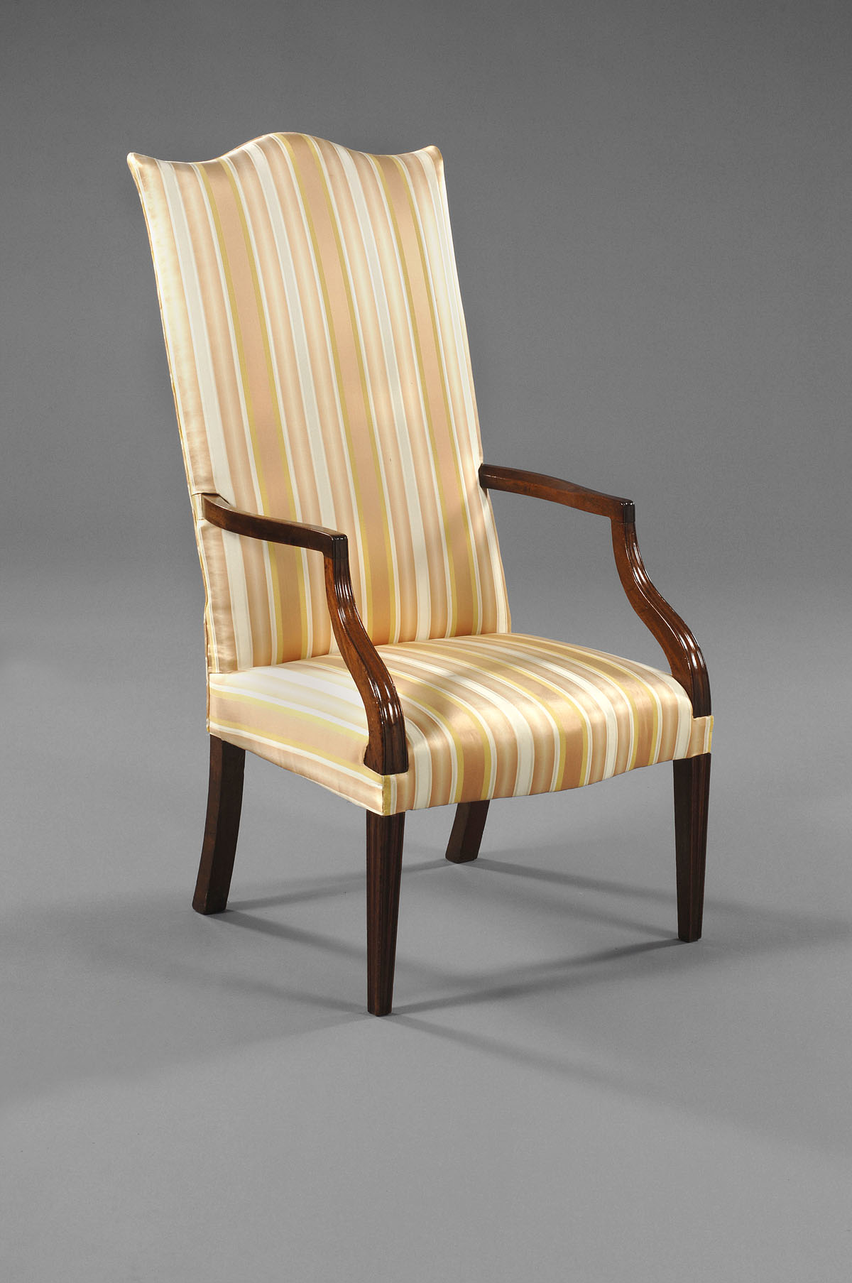 Appraisal: MASSACHUSETTS HEPPLEWHITE MAHOGANY LOLLING CHAIR The canted back with serpentine