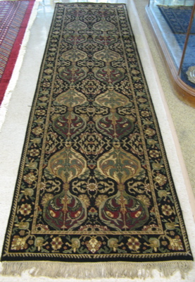 Appraisal: HAND KNOTTED ORIENTAL CORRIDOR CARPET Indo-Persian floral design on black