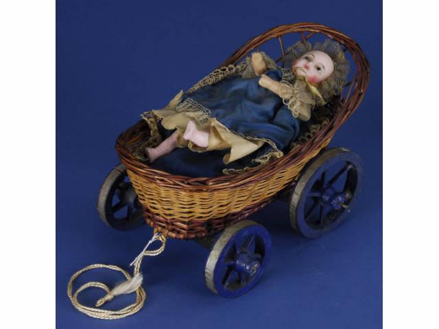 Appraisal: Wax Mechanical Child in Carriage Pull Toy Germany ca an