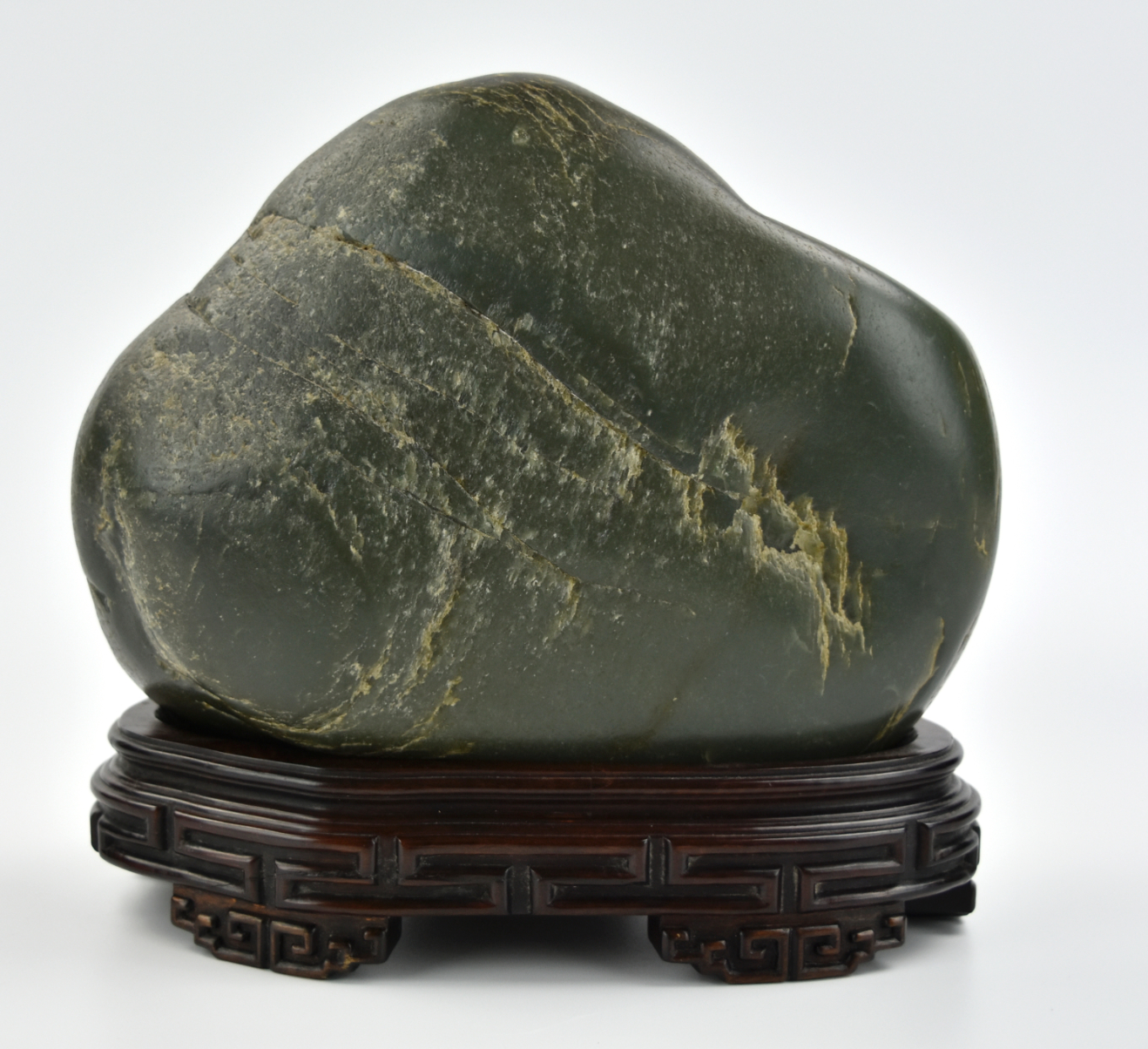 Appraisal: a green jade shanzi of a stone figure mounted with