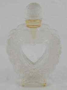 Appraisal: A mounted glass perfume bottle of heart form and impressed