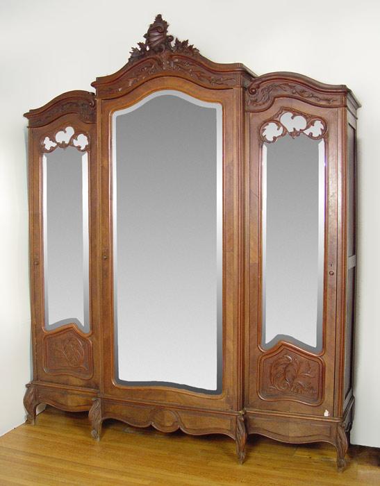 Appraisal: TH CENTURY FRENCH WALNUT TRIPLE DOOR ARMOIRE Three beveled mirror