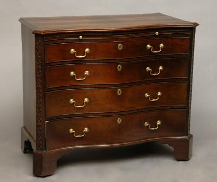 Appraisal: GEORGE III MAHOGANY SERPENTINE CHEST OF DRAWERS The solid serpentine