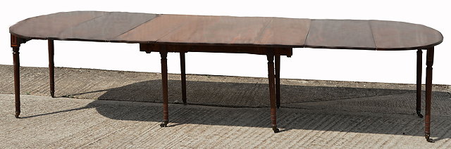 Appraisal: A GEORGE III MAHOGANY EXTENDING DINING TABLE with rounded ends